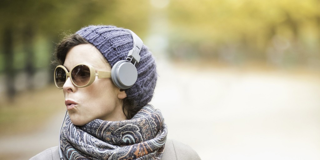 Woman listening to headphones in park