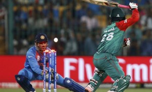 Cricket - India v Bangladesh - World Twenty20 cricket tournament - Bengaluru, India, 23/03/2016. India's captain and wicketkeeper Mahendra Singh Dhoni (L) stumps Bangladesh's Tamim Iqbal. REUTERS/Danish Siddiqui