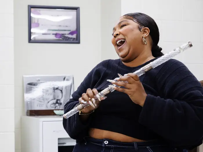 Lizzo playing crystal flute