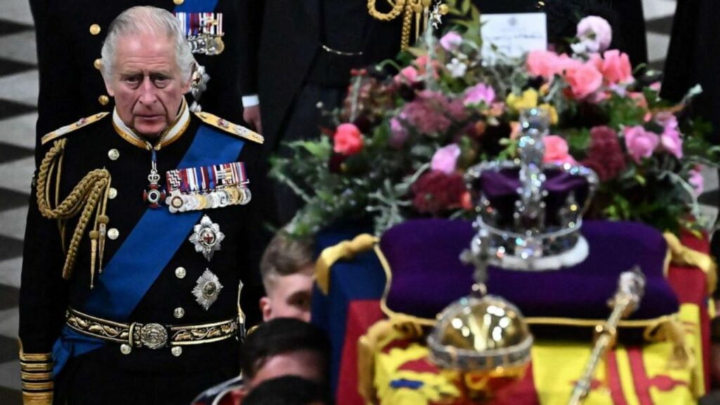 Britain's King Charles III walks beside The coffin of Queen Elizabeth II